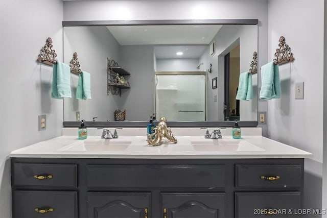 bathroom featuring double vanity, an enclosed shower, visible vents, and a sink