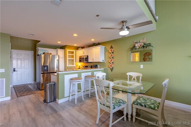 dining room with recessed lighting, visible vents, and light wood-style flooring