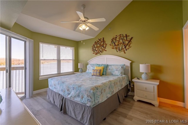 bedroom with vaulted ceiling, access to outside, light wood-style floors, and baseboards
