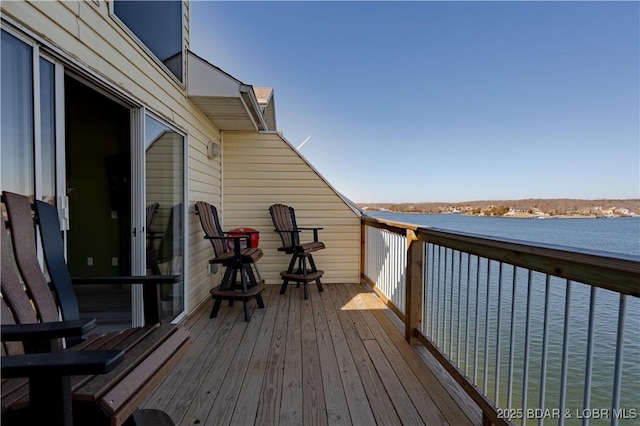 wooden deck featuring a water view