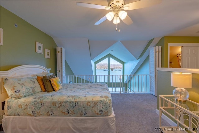 carpeted bedroom featuring a ceiling fan and vaulted ceiling