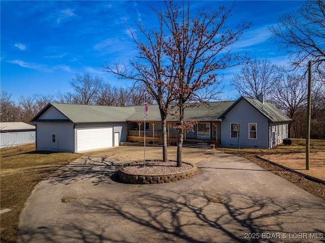 ranch-style house with crawl space, a garage, and driveway