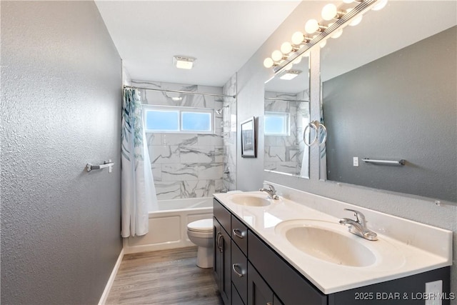 full bath featuring wood finished floors, toilet, shower / bath combo with shower curtain, and a sink