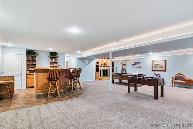 game room with carpet flooring, recessed lighting, baseboards, and indoor bar