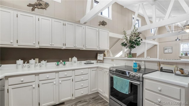 kitchen featuring electric range, white cabinets, and ceiling fan