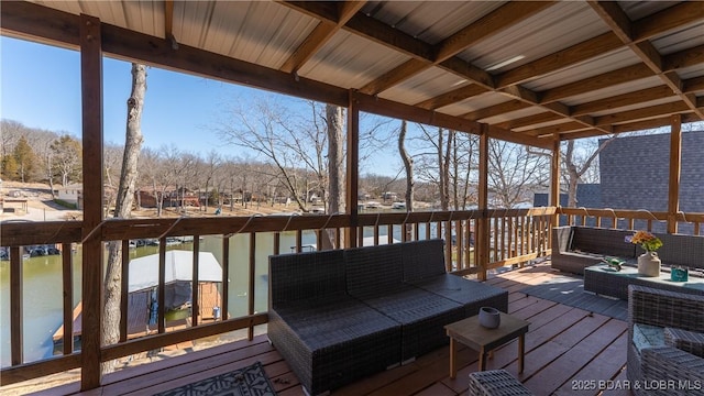 wooden terrace with an outdoor living space