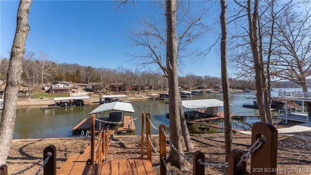 dock area with a water view and boat lift