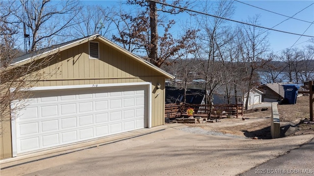 exterior space with a garage and an outbuilding