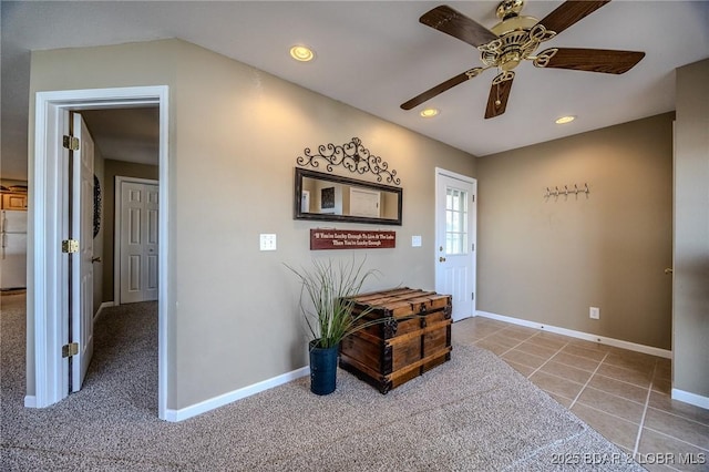 carpeted entrance foyer with recessed lighting, baseboards, ceiling fan, and tile patterned floors