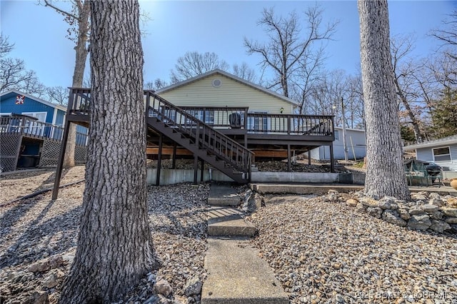 back of house with stairs and a deck