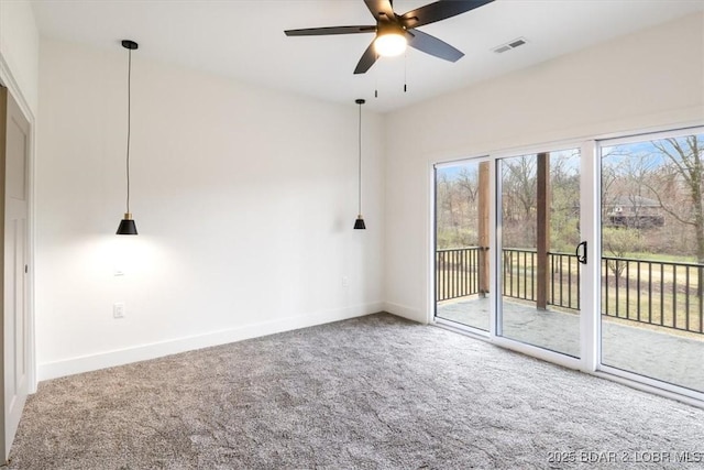 carpeted empty room featuring visible vents, baseboards, and a ceiling fan