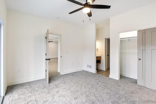 unfurnished bedroom featuring visible vents, baseboards, carpet, a closet, and a ceiling fan