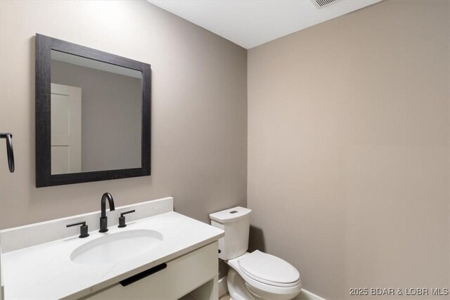 bathroom featuring toilet and vanity