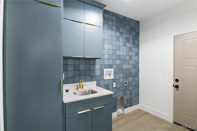 bathroom with vanity, tile walls, wood finished floors, and baseboards