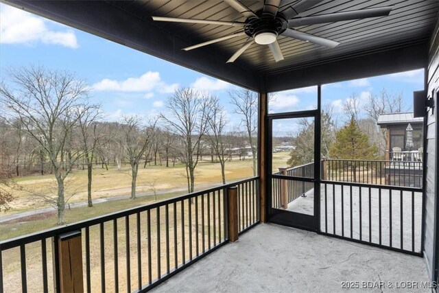 unfurnished sunroom featuring a ceiling fan