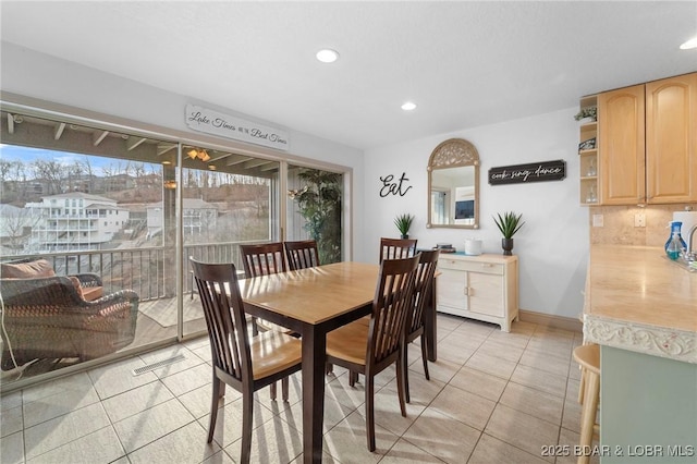 dining area featuring light tile patterned flooring, recessed lighting, and baseboards