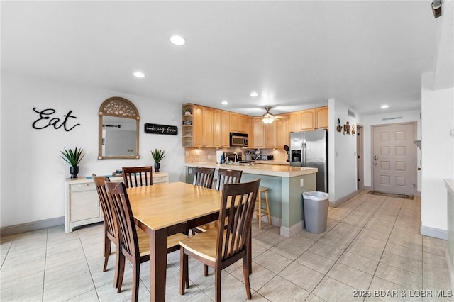 dining area with a ceiling fan, light tile patterned floors, recessed lighting, and baseboards