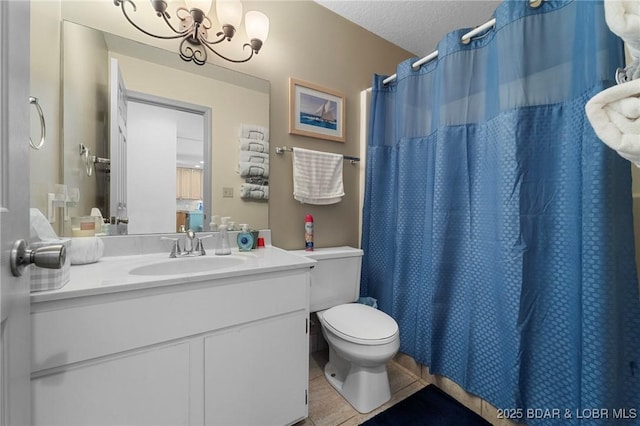 bathroom with vanity, an inviting chandelier, a textured ceiling, tile patterned floors, and toilet