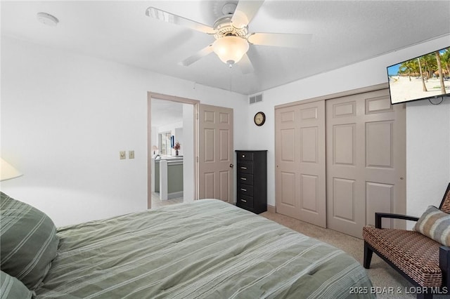 bedroom with a closet, visible vents, carpet flooring, and a ceiling fan