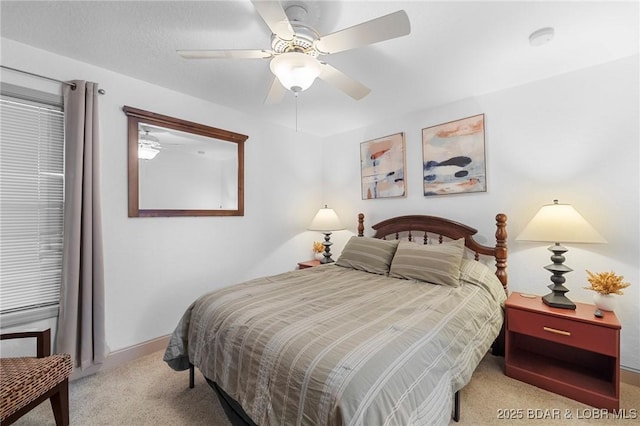 bedroom featuring baseboards, carpet floors, and a ceiling fan