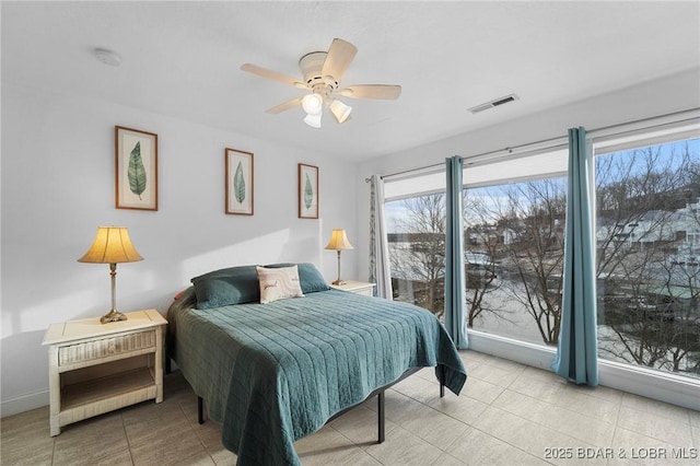 bedroom with tile patterned flooring, baseboards, visible vents, and ceiling fan