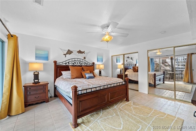 bedroom featuring multiple windows, a ceiling fan, visible vents, and two closets