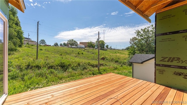 deck featuring a storage shed and an outdoor structure