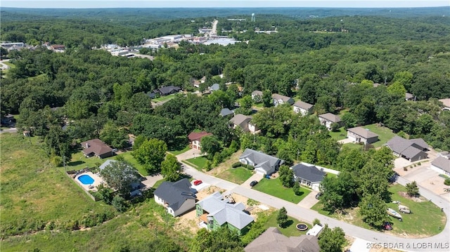 birds eye view of property featuring a forest view and a residential view