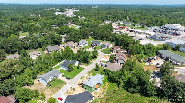 birds eye view of property featuring a view of trees and a residential view