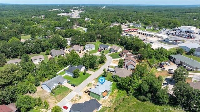 birds eye view of property with a residential view and a view of trees