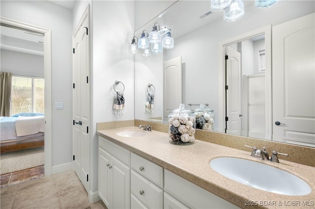 bathroom featuring double vanity, visible vents, ensuite bathroom, and a sink