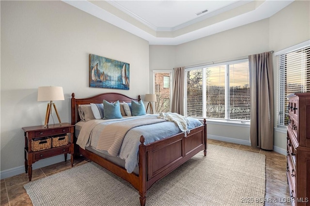 bedroom featuring visible vents, crown molding, a raised ceiling, and baseboards