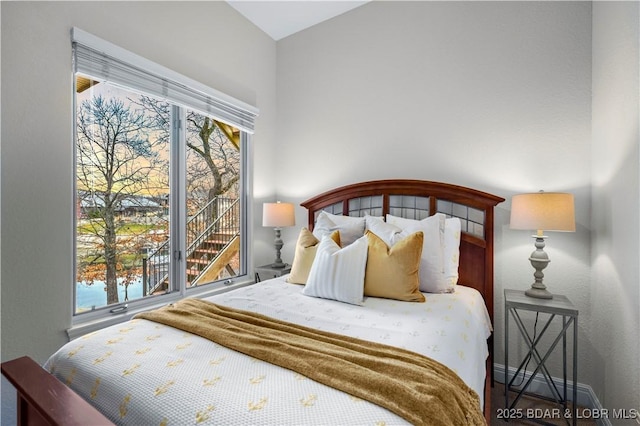 bedroom with baseboards and multiple windows