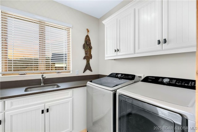 laundry room with a sink, cabinet space, and washer and dryer