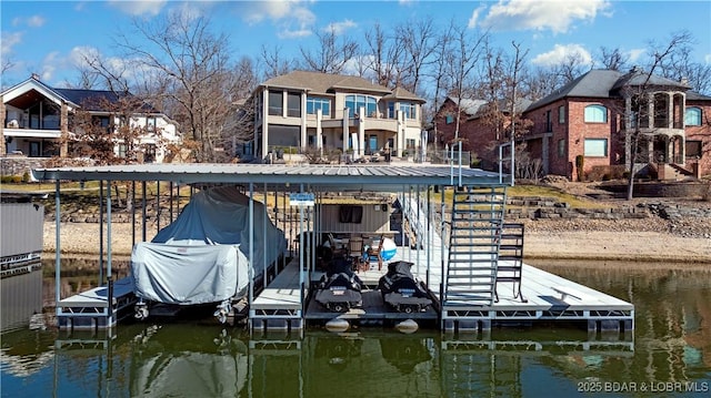 dock area featuring boat lift, stairway, a residential view, and a water view