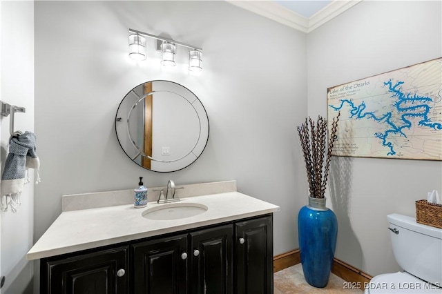 half bathroom with vanity, crown molding, and toilet