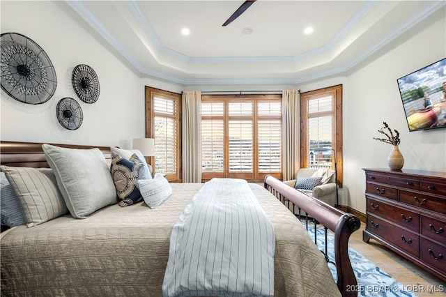 bedroom featuring recessed lighting, a raised ceiling, light wood-style flooring, and ornamental molding