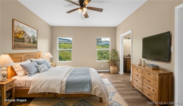 bedroom with baseboards, light wood-style floors, and ceiling fan