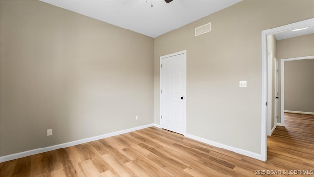 unfurnished bedroom with visible vents, baseboards, light wood-style floors, and a ceiling fan