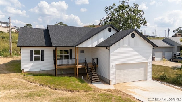 view of front of home with driveway, covered porch, a shingled roof, a garage, and stairs