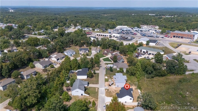 bird's eye view featuring a forest view and a residential view