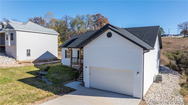 view of property exterior with a garage, a yard, and a shingled roof