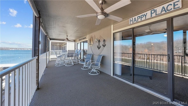 unfurnished sunroom with a water view and ceiling fan