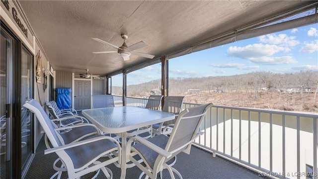 balcony featuring ceiling fan and outdoor dining space