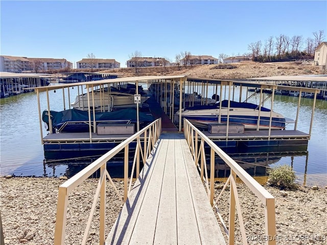 view of dock featuring boat lift and a water view