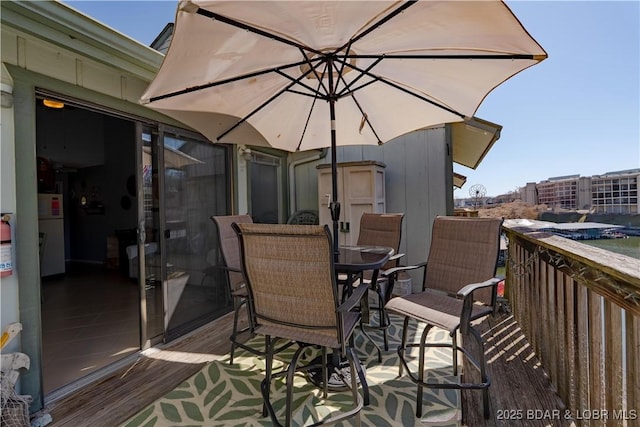 wooden terrace featuring outdoor dining area