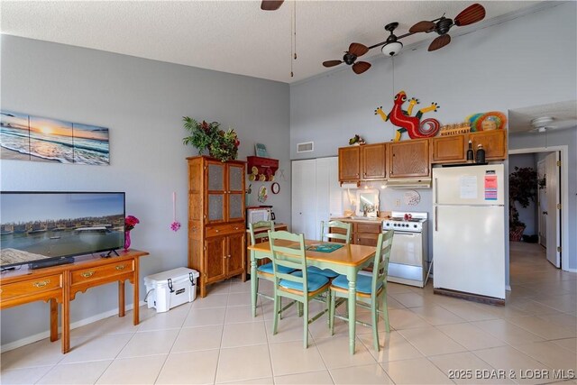 123 Southwood Shores Dr Unit 4C, Lake Ozark, MO 65049 - dining area with ceiling fan, a textured ceiling, and light tile patterned floors