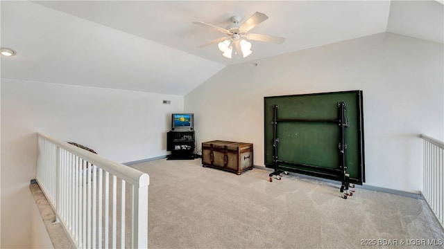 additional living space with carpet flooring, baseboards, lofted ceiling, and a ceiling fan