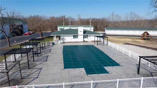 view of pool with a patio area and fence