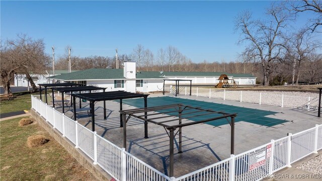 exterior space featuring a patio area, a fenced in pool, and fence